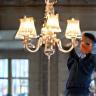 Technician installing chandelier
